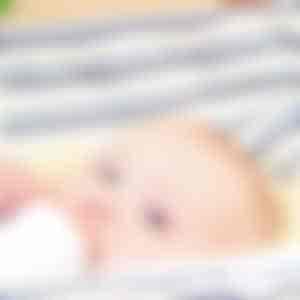 Baby with bottle in children's hammock - CHICO